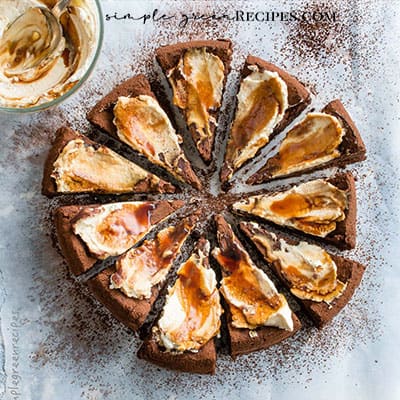 Vegan Flourless Chocolate Cake with whipped cream and caramel.