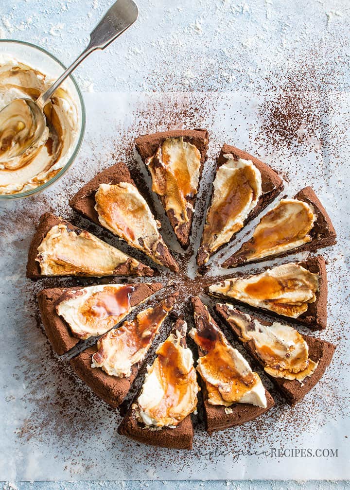 Vegan Flourless Chocolate Cake topped with whipped cream and caramel