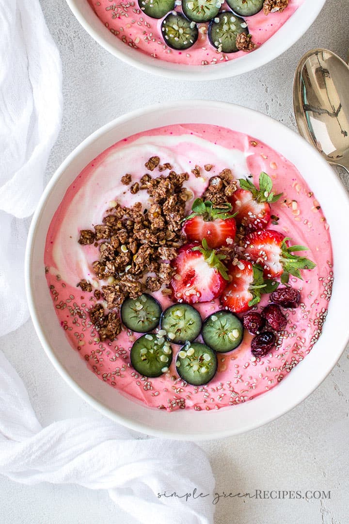 Over head shot of the easy Strawberry Banana Smoothie Bowl topped with fresh and dried berries and granola.