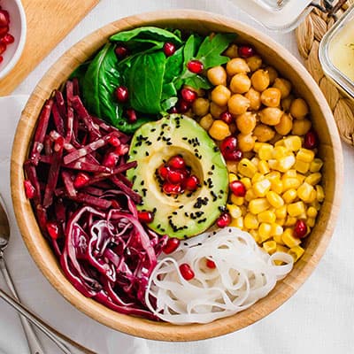 Overhead shot of the Vegan Buddha Bowl with legumes, noodles, fresh veggies and avocado.