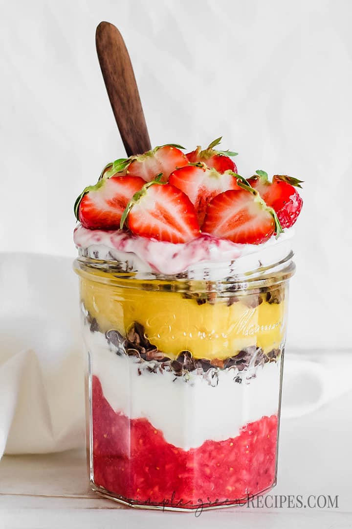 Eye-level shot Vegan Strawberry Parfait topped with halved strawberries.