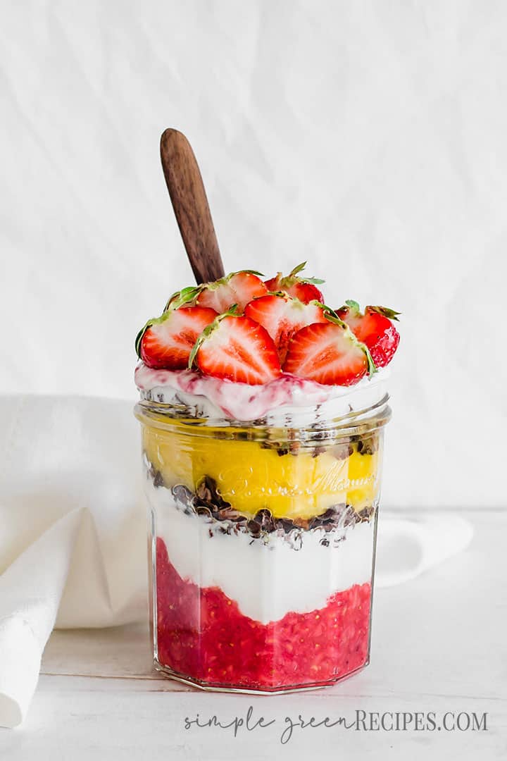 Eye-level shot of the layered Strawberry Parfait dessert topped with halved berries.