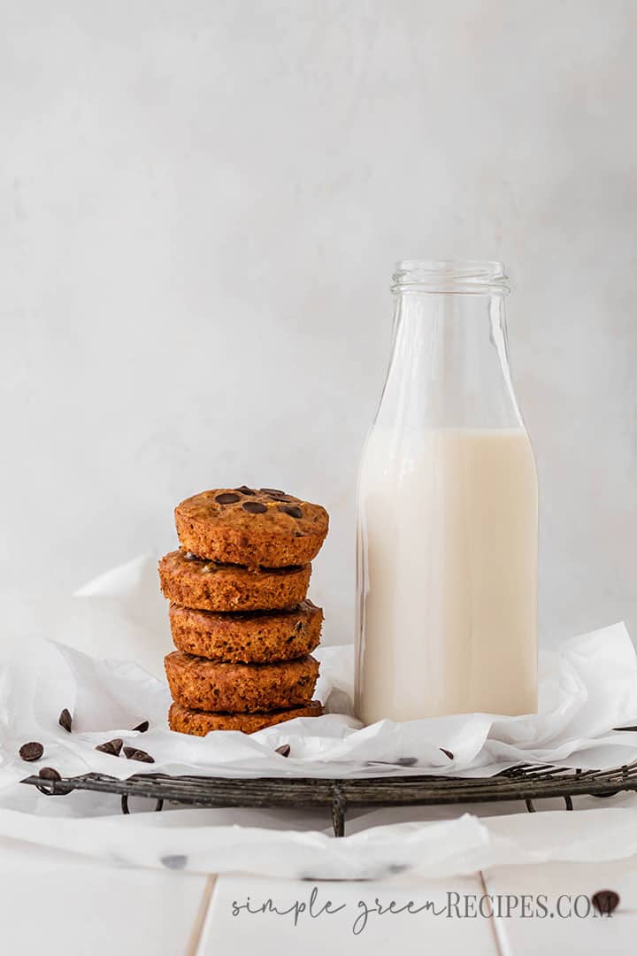 Eye level shot of a stack cookies next to a bottle of milk.