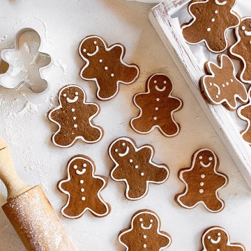 Over head shot of the gingerbread man cookies on a white surface.