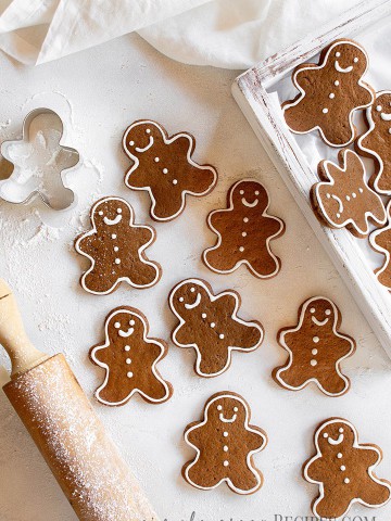 Over head shot of the gingerbread man cookies on a white surface.