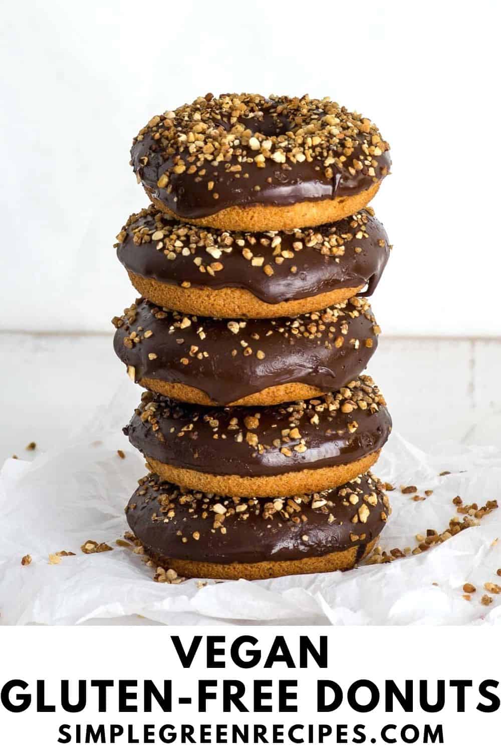 stack of baked donuts topped with chocolate frosting and crunchy almonds