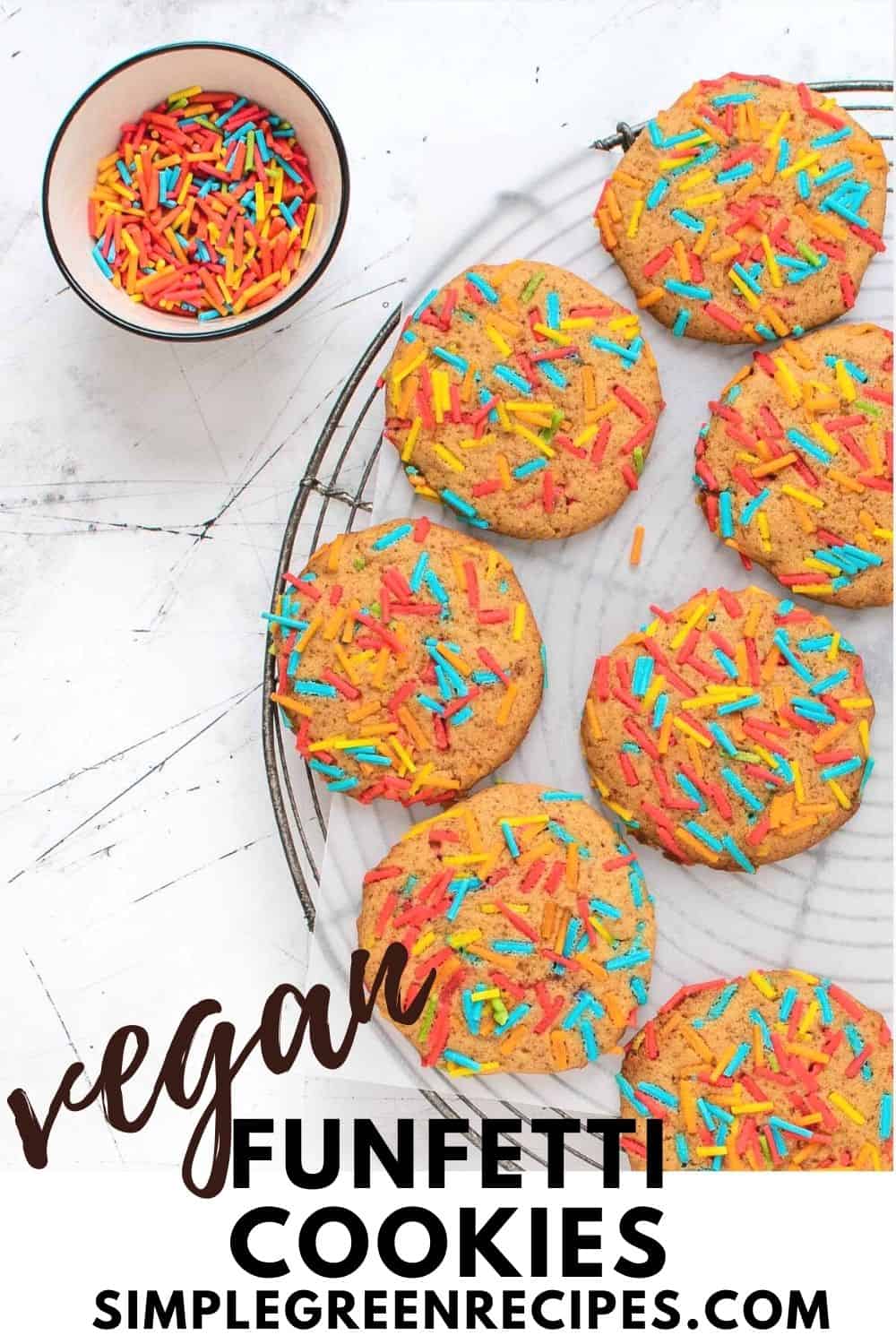 Sprinkle Cookies on a round cooling rack and a bowl full of colourful sprinkles