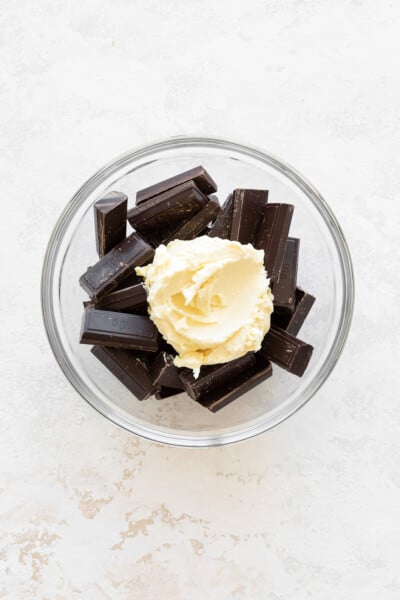 Chocolate chunks and butter in a glass bowl