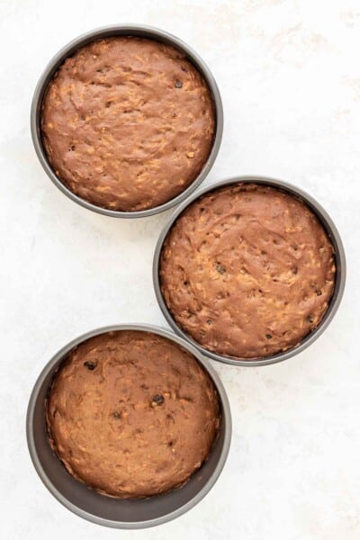 three cake pans with baked cakes inside