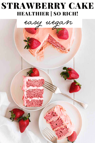 3-layer strawberry cake, sliced and topped with fresh strawberries.